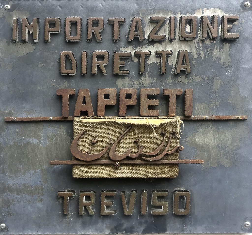 The historic metal sign: direct rug imports, Treviso